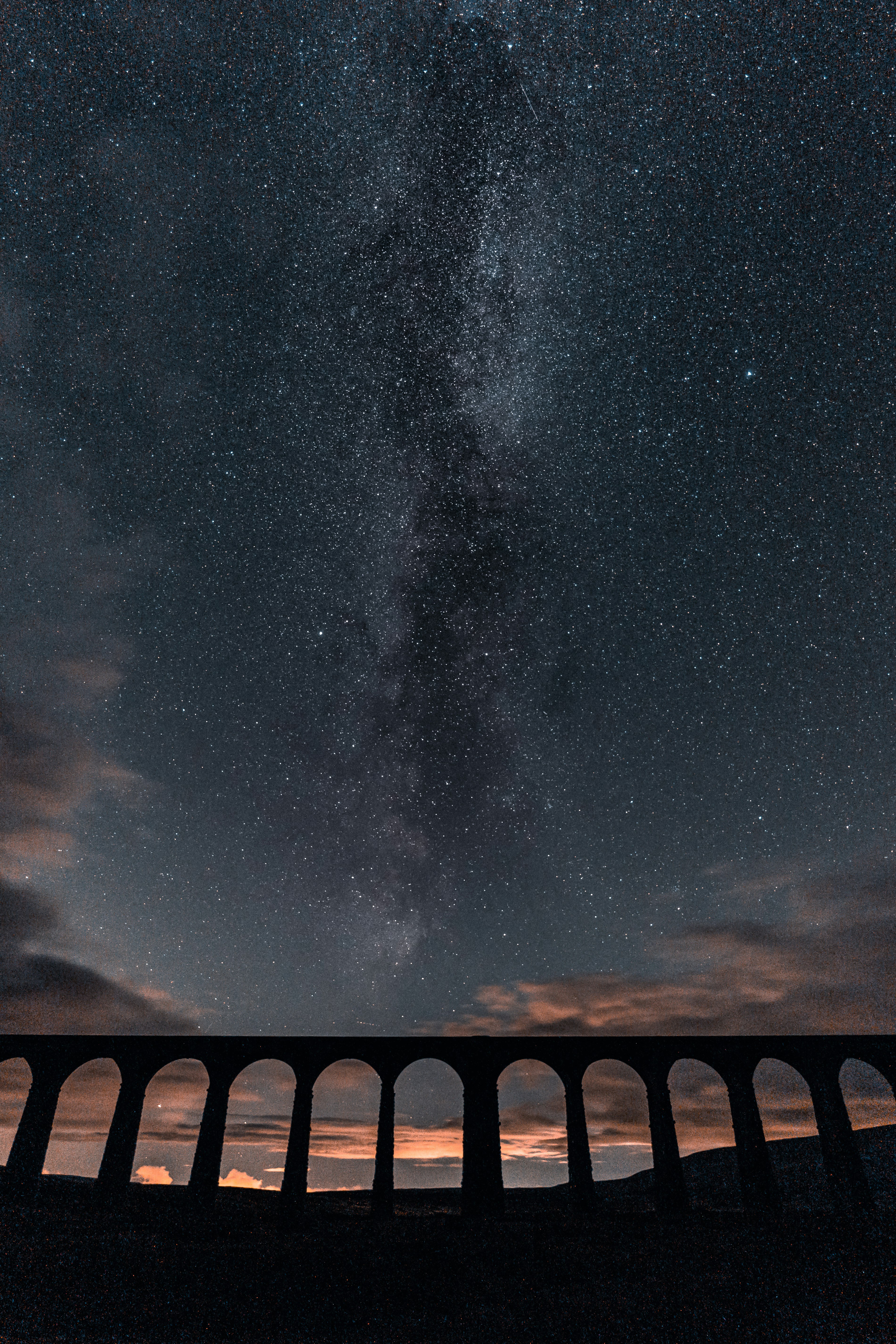 brown concrete bridge under starry night